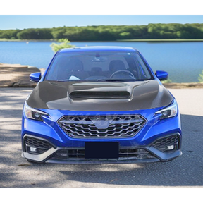 Low angle perspective of the Fits 2022-2024 Subaru WRX with its Real Carbon Fiber Front Engine Hood, accentuating the vehicle's streamlined profile