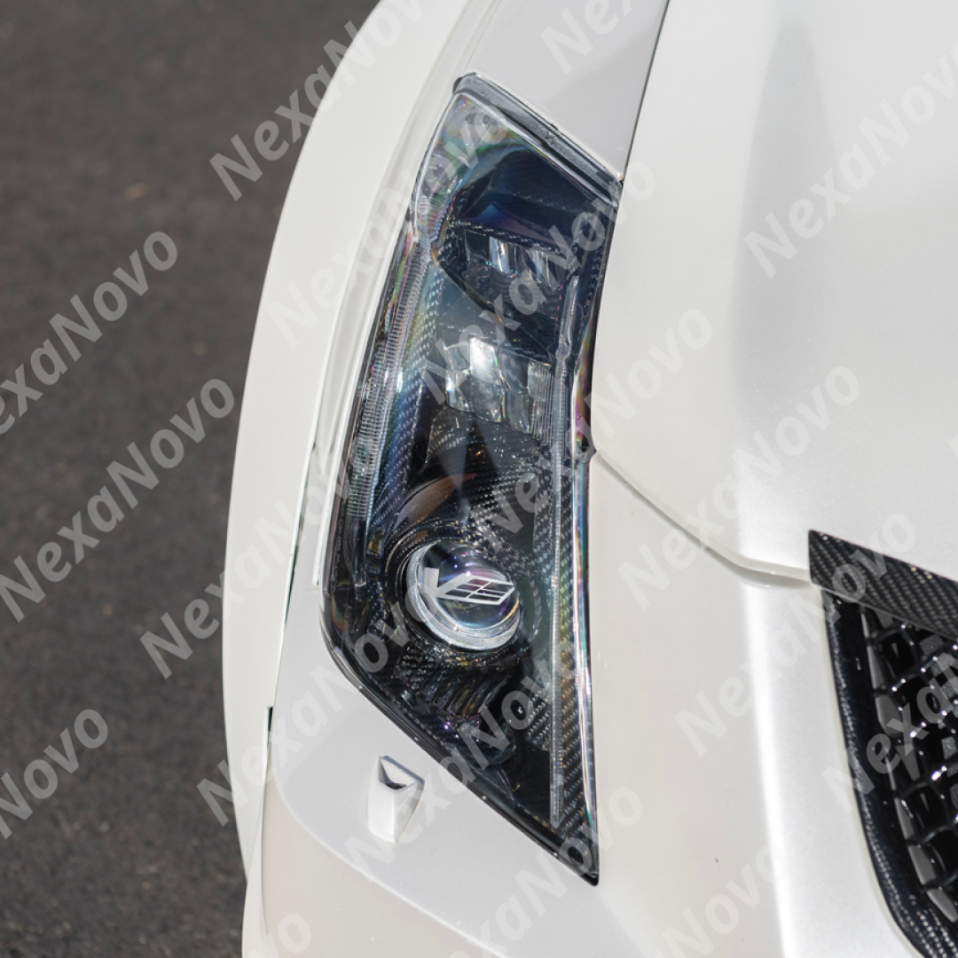 NexaNovo carbon fiber internal lens cover on a white Cadillac CTS-V
