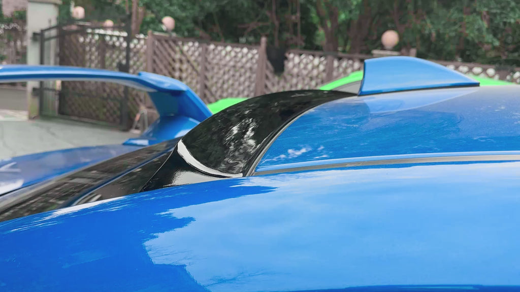 Gloss black roof visor providing a sporty contrast on a World Rally Blue Subaru STI