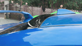 Gloss black roof visor providing a sporty contrast on a World Rally Blue Subaru STI